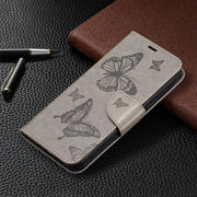 For iPhone 16 Embossing Two Butterflies Pattern Leather Phone Case(Grey)