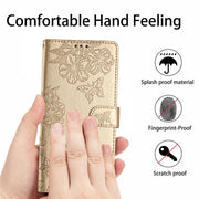 For iPhone 16e Cherry Blossom Butterfly Skin Feel Embossed PU Phone Case(Gold)