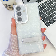 For Samsung Galaxy S25 5G Plating Glitter Texture Fold Holder TPU Phone Case with Lens Film(White Shell Pattern)