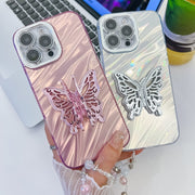For iPhone 16 Plating Glitter Lens Film Texture Butterfly Holder Wristband Phone Case(Pink Tinfoil Texture)