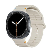 For Samsung Galaxy Watch8 40mm Speed Bezel and Wavy Grain Stitched Color Buckle Silicone Watch Band(Beige Black)